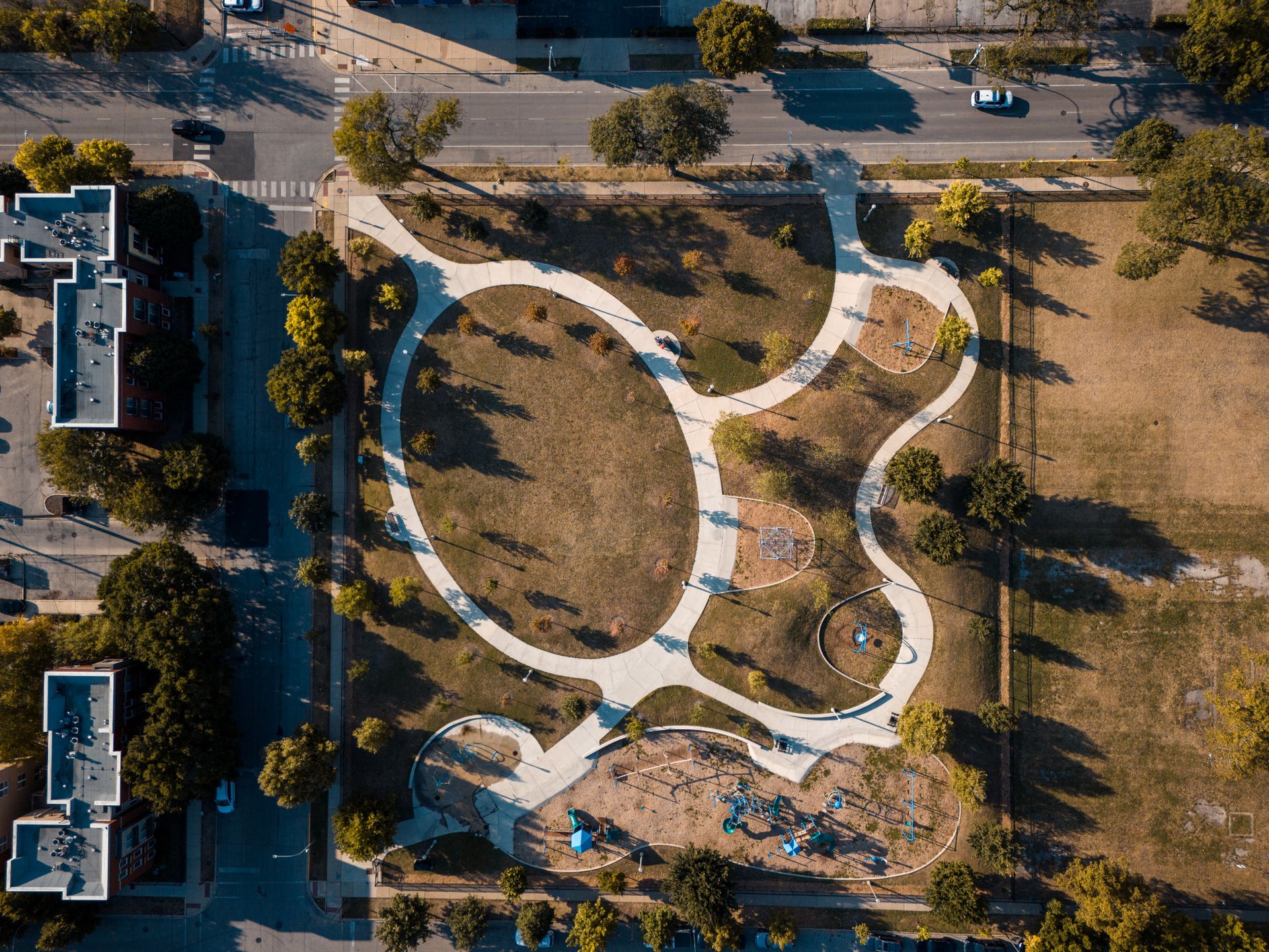 Aerial view of park pathways and green space in a development
