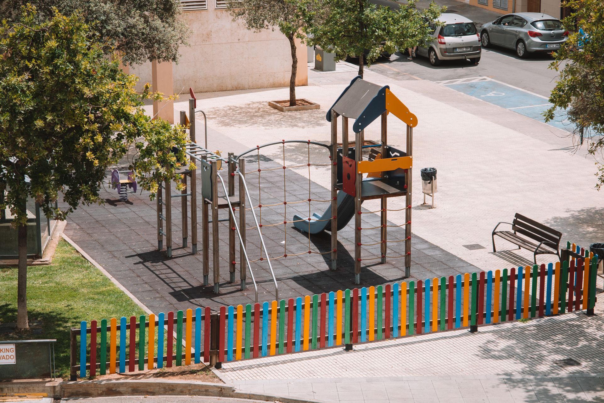 Playground enclosed by a colorful fence